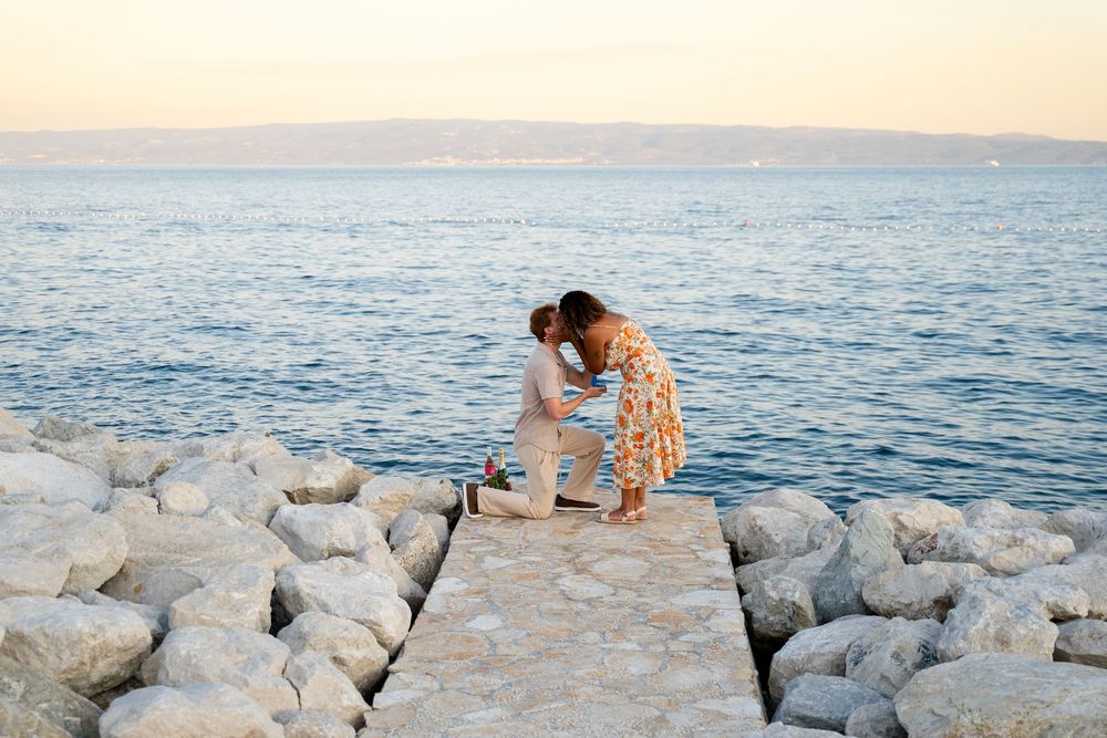 Beach surprise proposal at Žnjan Beach, Split, Croatia captured by Split proposal photographers during a romantic sunset engagement.