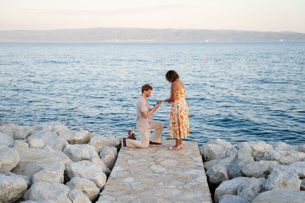 Beach surprise proposal at Žnjan Beach, Split, Croatia captured by Split proposal photographers during a romantic sunset engagement.