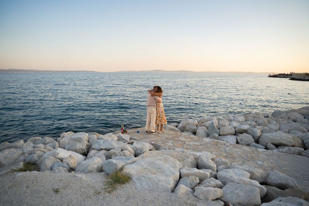 Beach surprise proposal at Žnjan Beach, Split, Croatia captured by Split proposal photographers during a romantic sunset engagement.