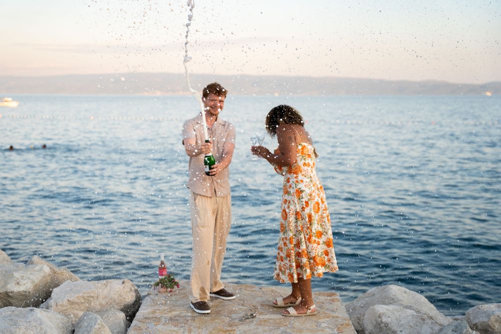 Beach surprise proposal at Žnjan Beach, Split, Croatia captured by Split proposal photographers during a romantic sunset engagement.