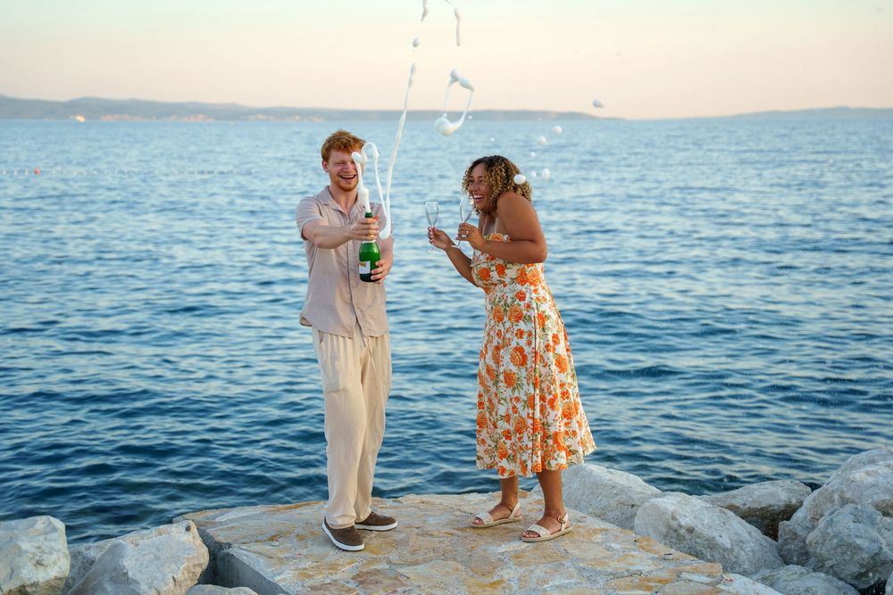 Beach surprise proposal at Žnjan Beach, Split, Croatia captured by Split proposal photographers during a romantic sunset engagement.