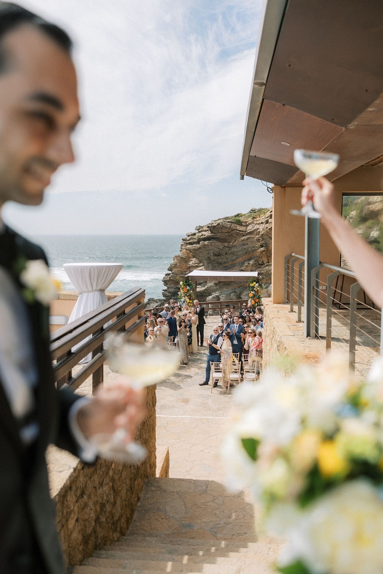 Newlyweds enjoying cocktails overlooking the Atlantic Ocean after their destination wedding ceremony.