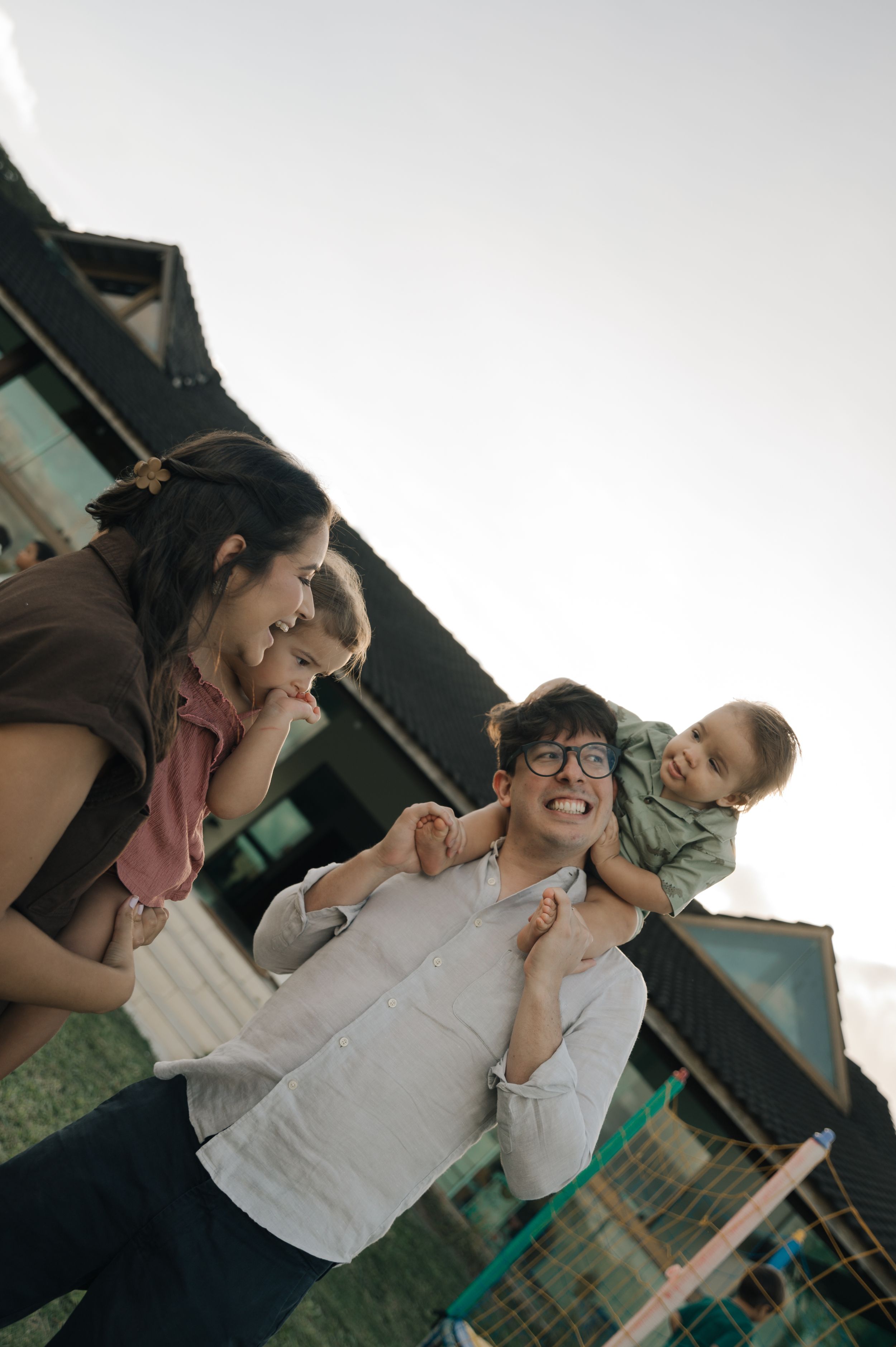 Three connected photos show a tender moment between family members laughing and embracing outdoors.