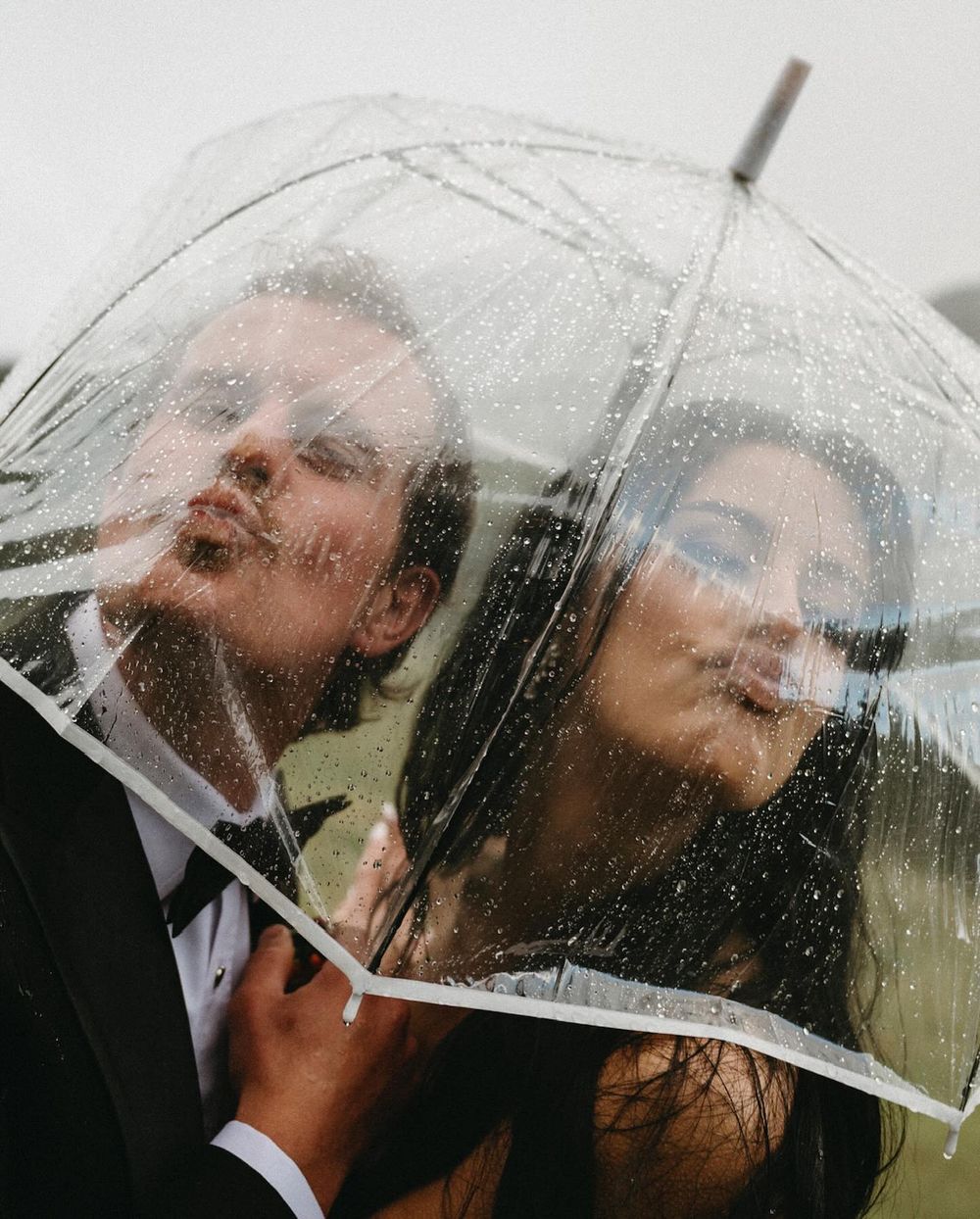 Sarah and Lee under a clear umbrella in the rain, Banff wedding photographer