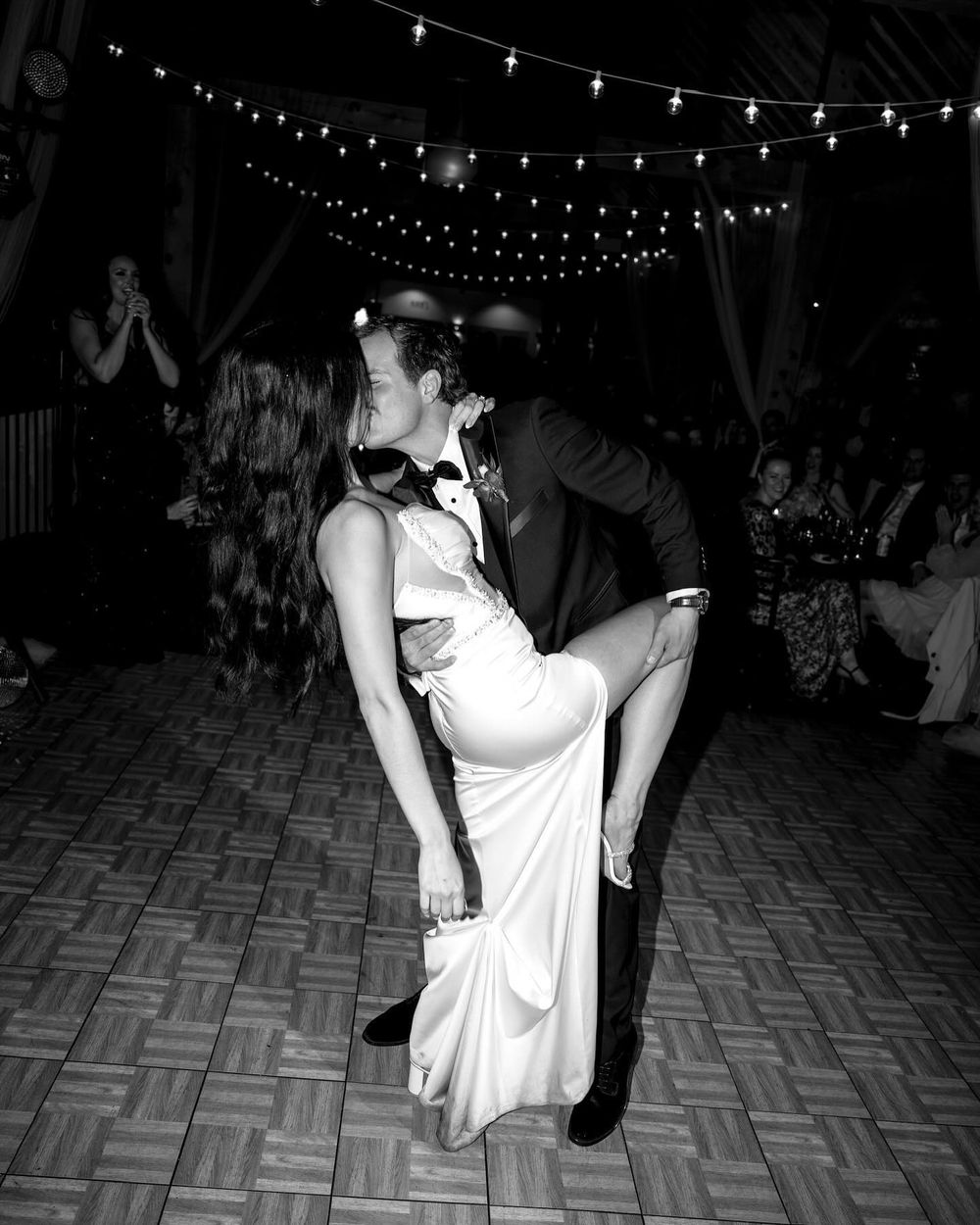 Black and white first dance under string lights, Mount Norquay Banff wedding