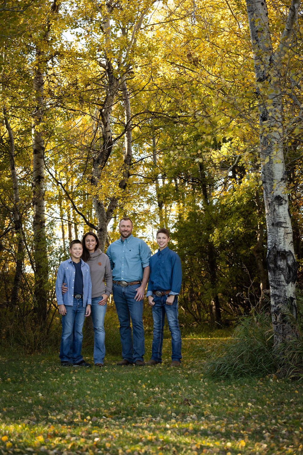 mom, dad and two sons in fall surroundings