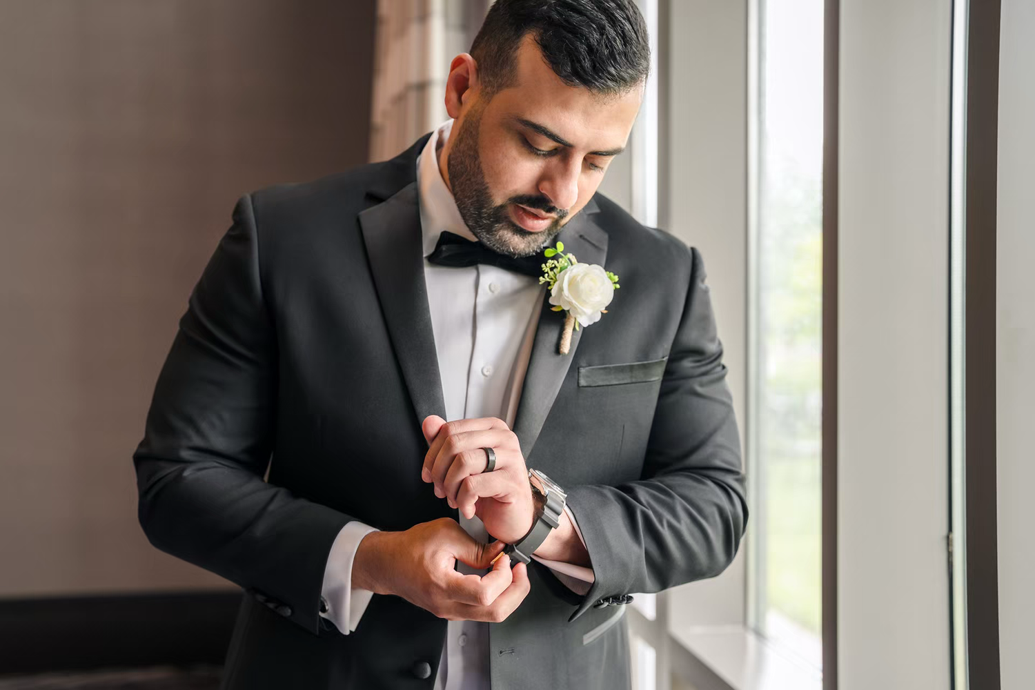 Groom getting ready in renaissance wedding venue.