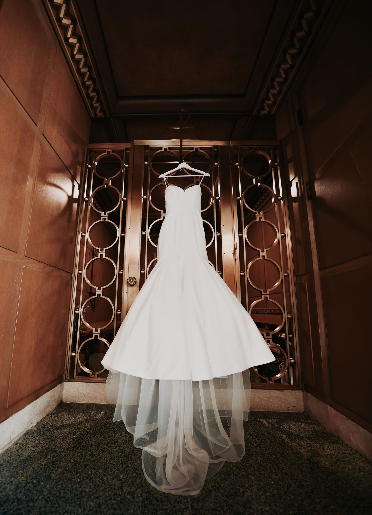 bridal gown hanging on the door
