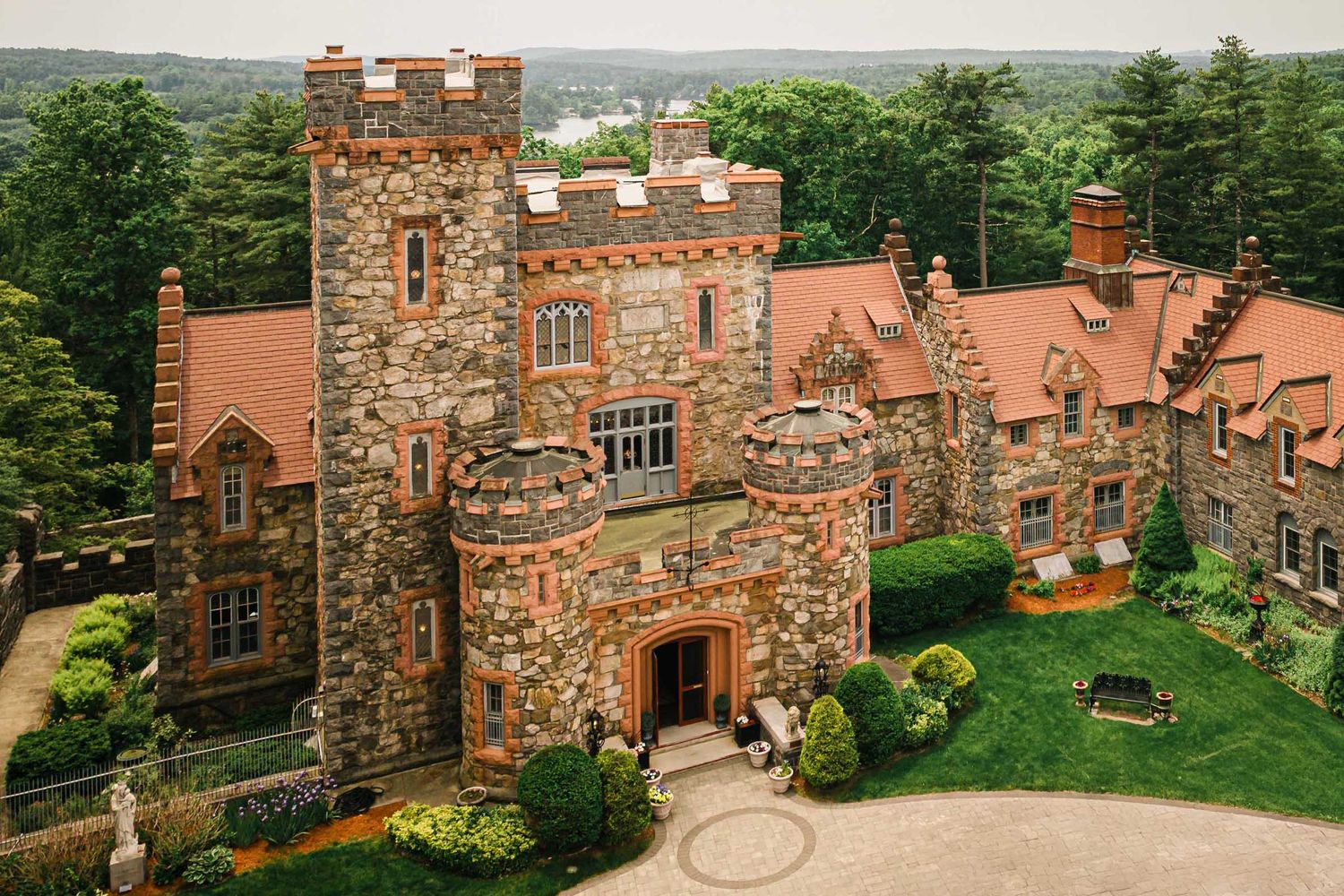 Aerial close-up of Searles Castle's stone towers and courtyard entrance in Windham, NH, the setting for this wedding day.