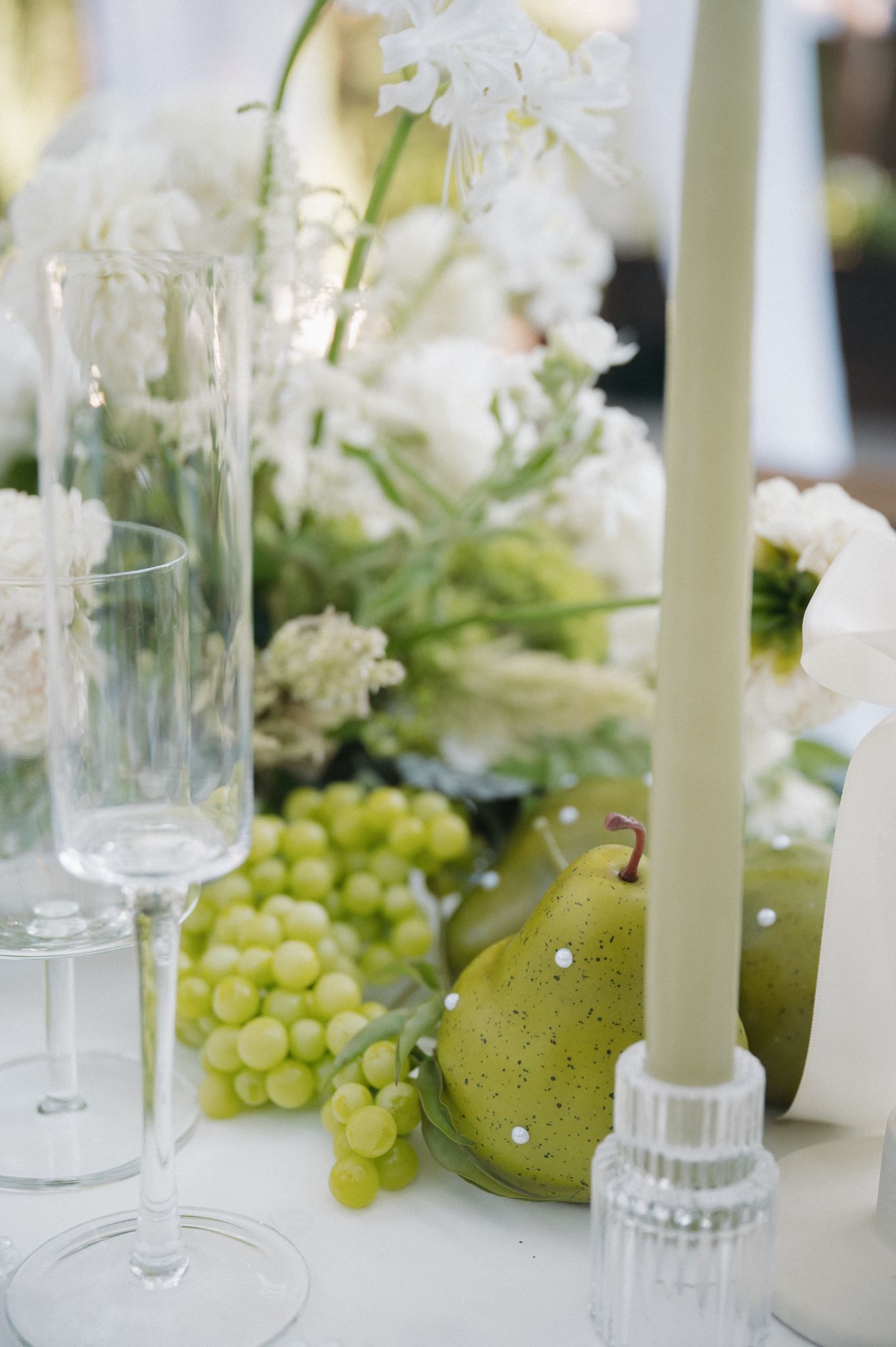 Elegant wedding table with green grapes, pear, white candles at Oak Atelier in Conroe, Texas.
