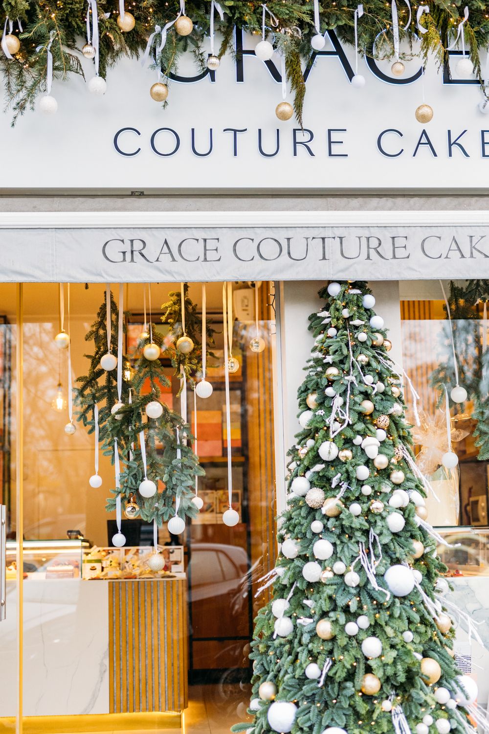 Grace Couture Cakes storefront decorated with Christmas tree, ornaments, and festive greenery for the holiday season.