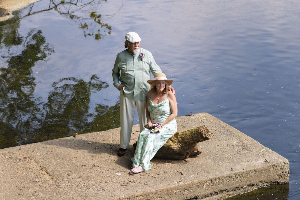 Karen and George sitting together on the dock during wedding portraits