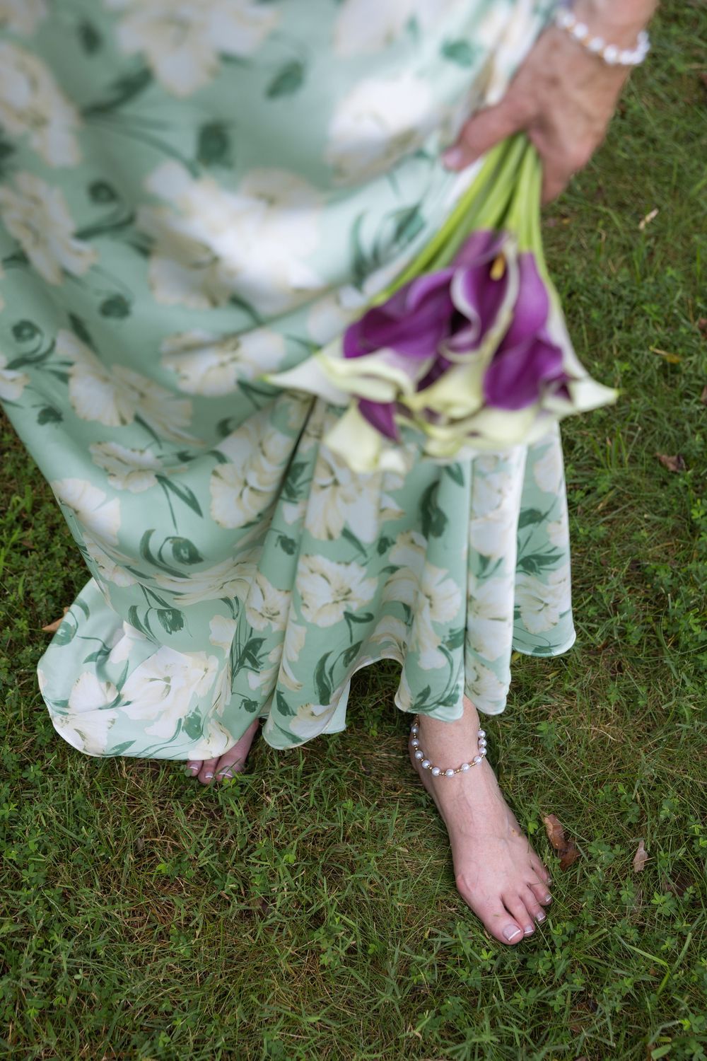 Karen walking barefoot with her bouquet after the wedding ceremony