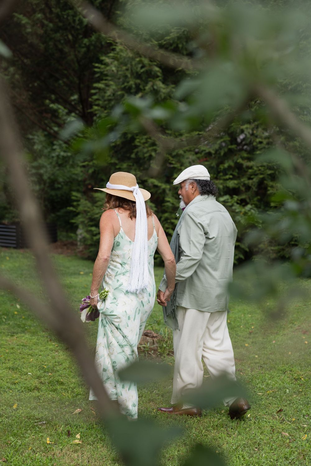 Karen and George walking together across the lawn at River Dell Bed and Breakfast