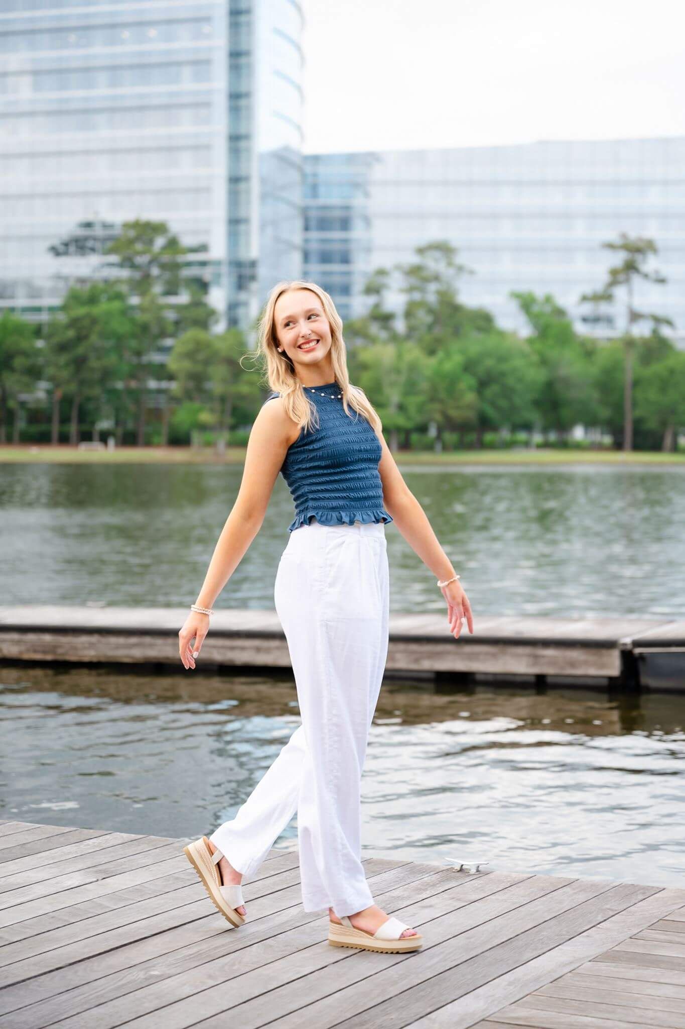 Klein Oak High School senior girl posing on a boat dock in The Woodlands Texas