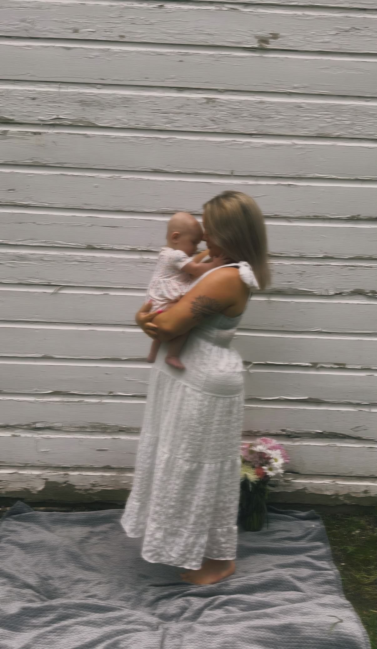 Mother holding her baby during an outdoor motherhood photography session