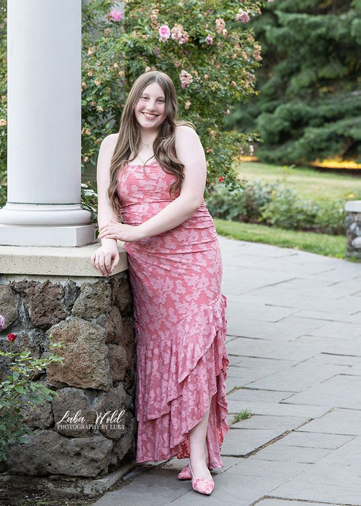 Spokane senior girl in a maxi long pink dress in Manito Park by photographer Luba Wold in Post Falls