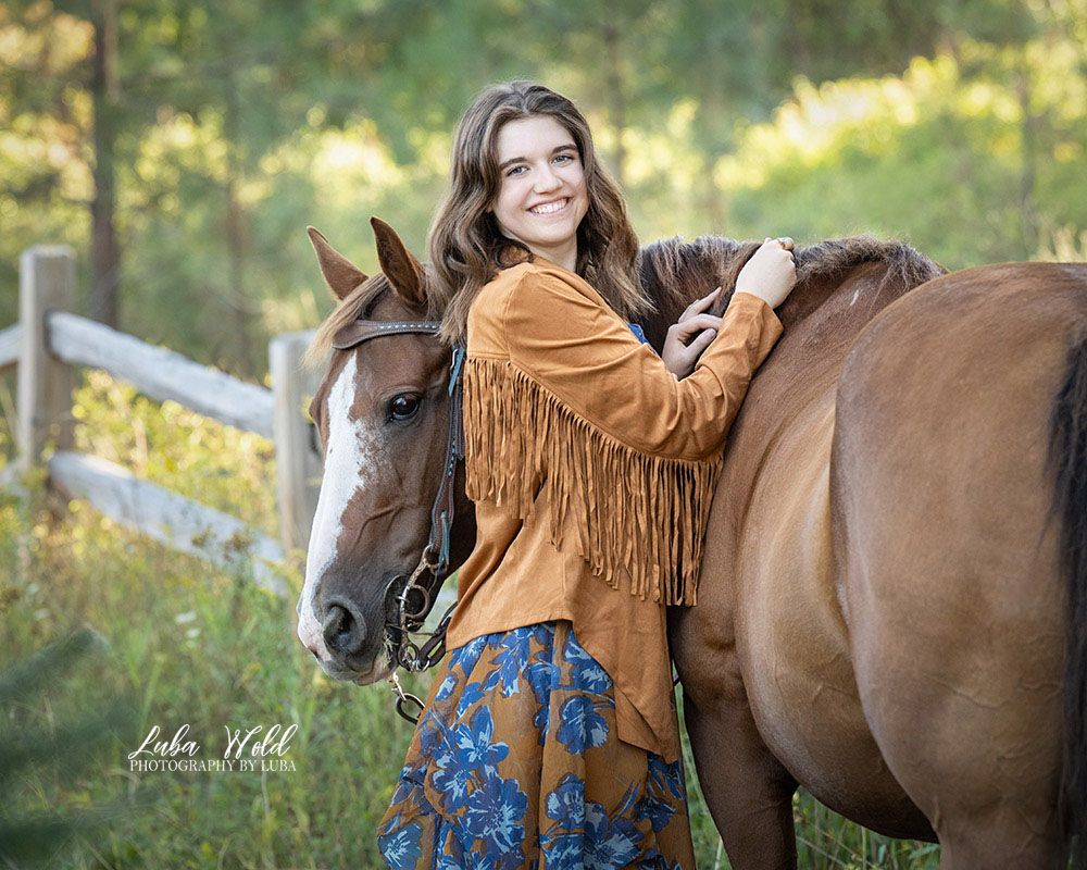 high school senior girl outdoor portrait with her horse by photographer Luba Wold in Post Falls on a ranch