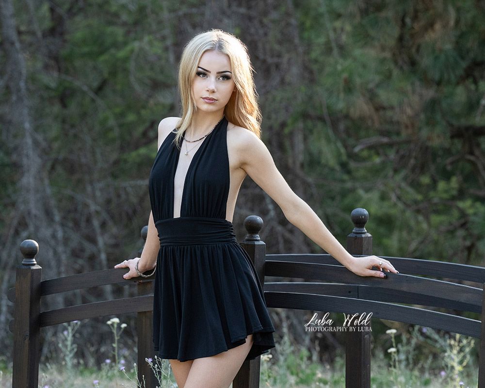 high school senior girl in black short dress in the woods by Post Falls photographer Luba Wold