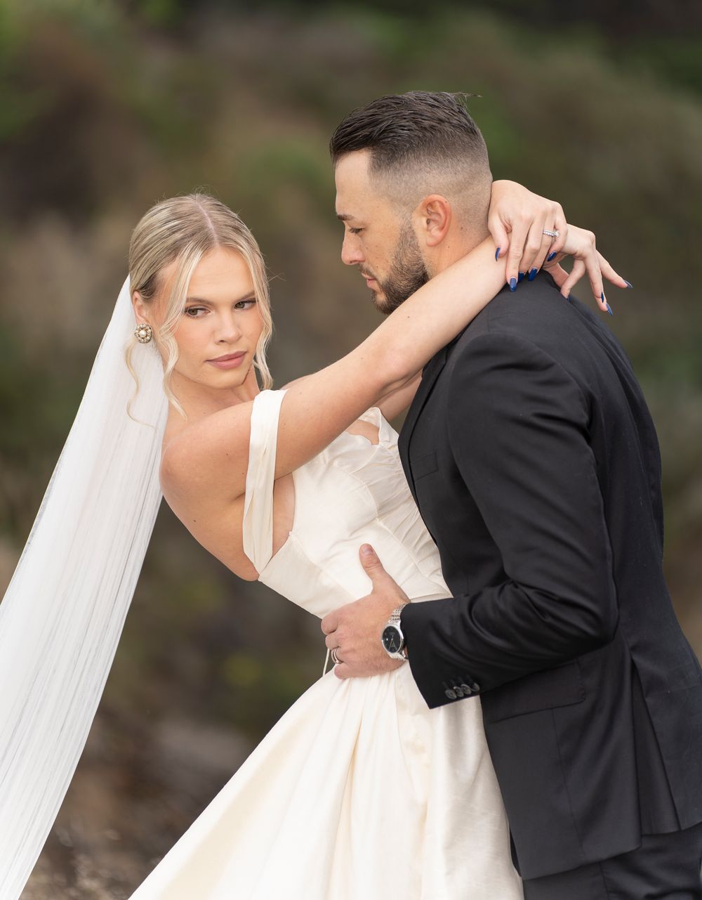 A romantic wedding photoshoot sequence showing a couple in formal attire sharing intimate moments outdoors.