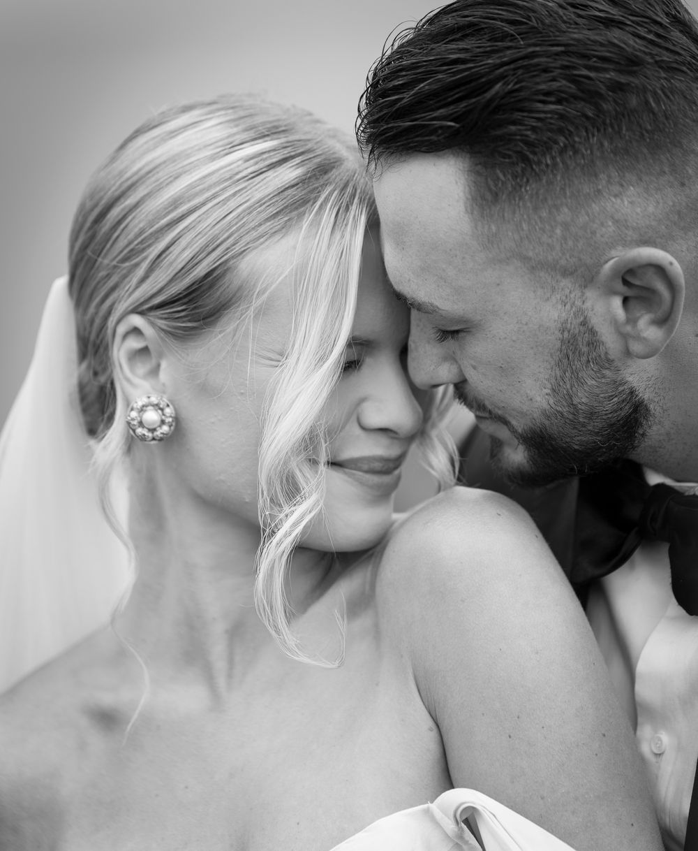 Intimate black and white close-up portraits of a romantic couple sharing tender moments together.