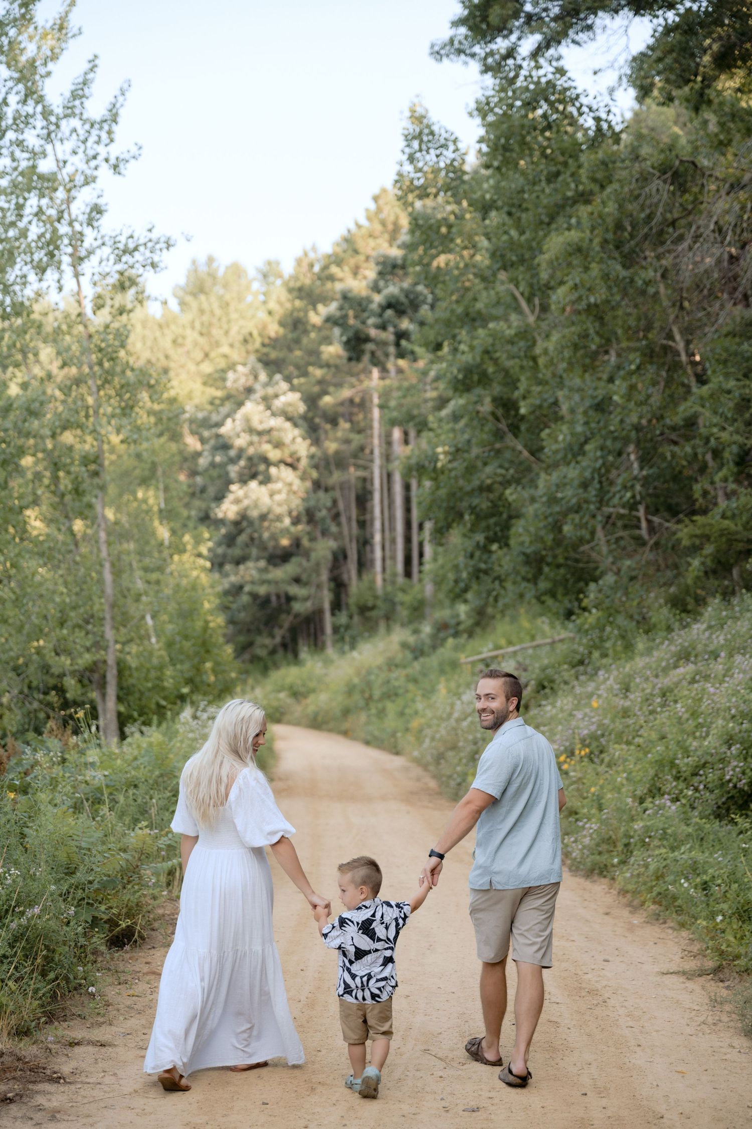 family holding hands walking during an outdoor family session in Hudson, Wisconsin