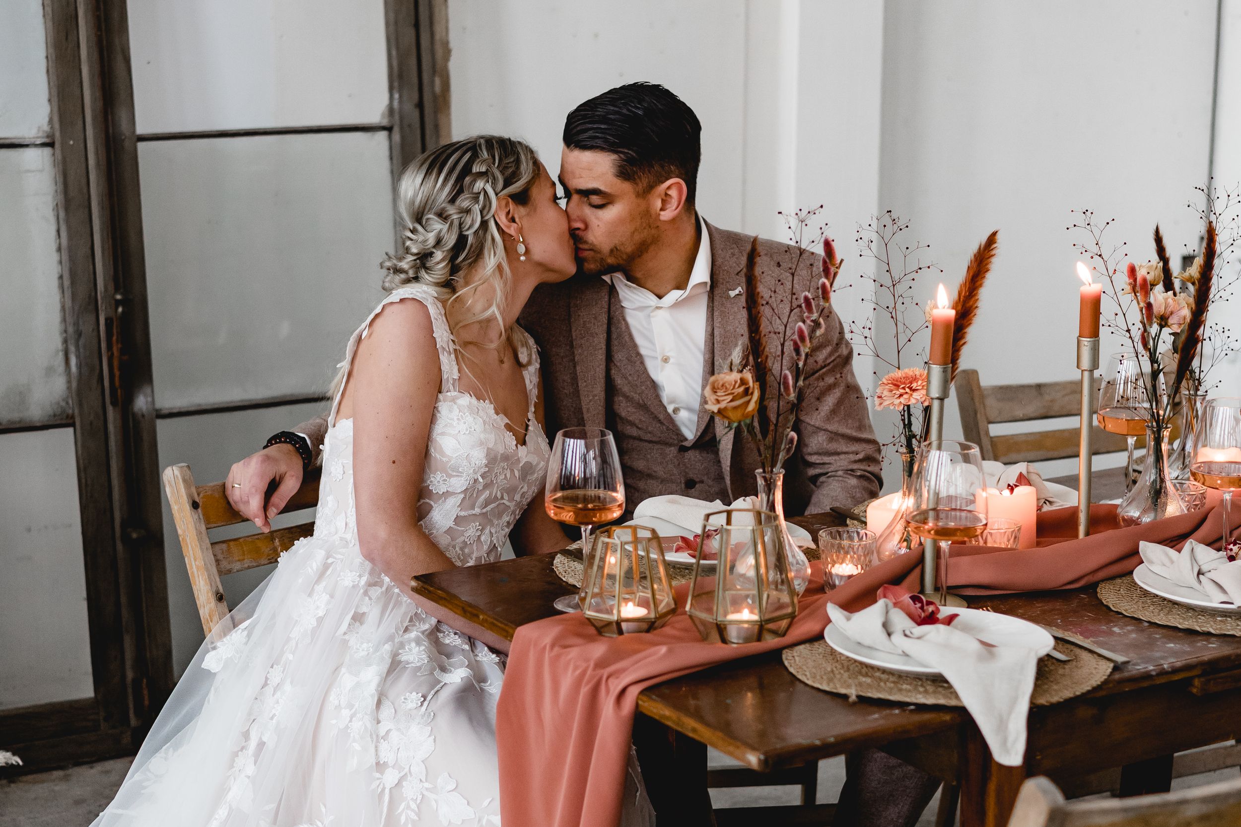 Elegant wedding table settings with white linens and pink accents create a romantic dining atmosphere.