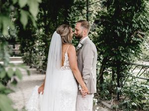 Romantic garden wedding portraits with natural greenery and ivy backdrop.