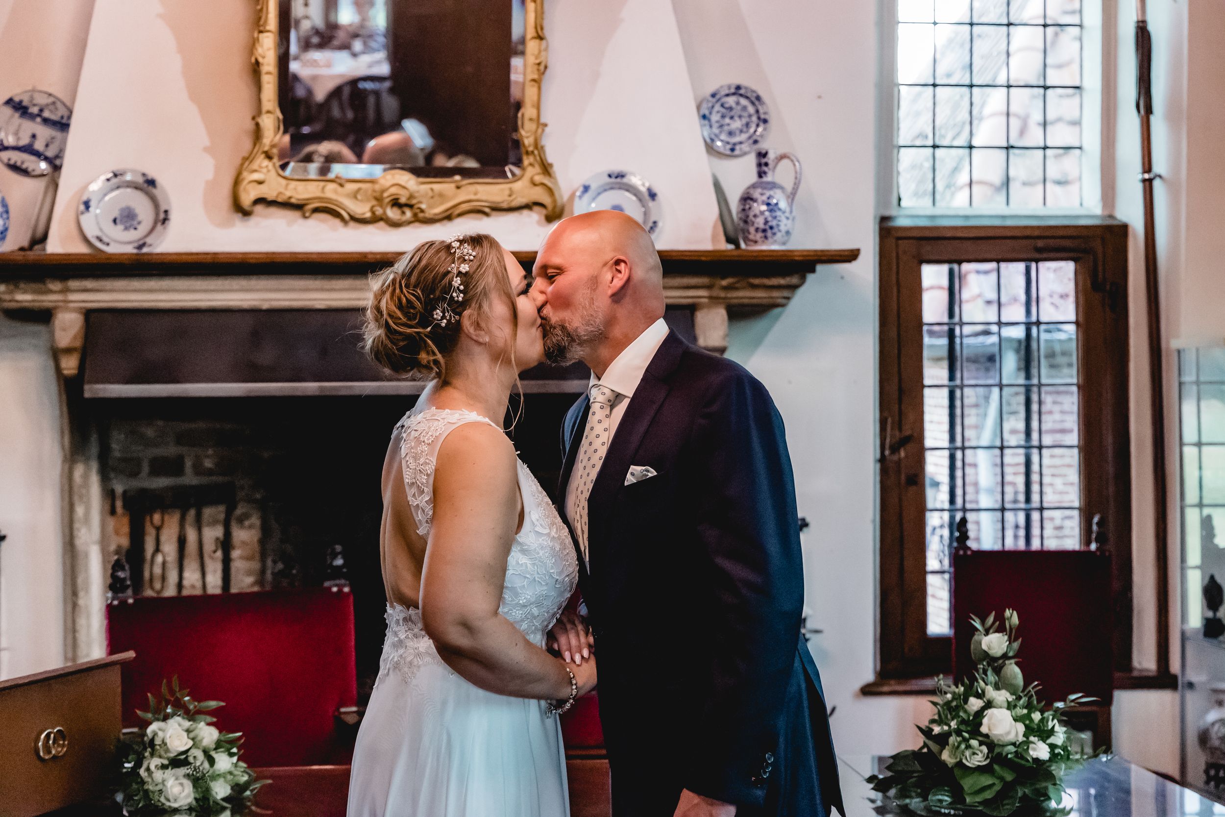 Romantic wedding ceremony moments captured inside a traditional church with floral decorations.