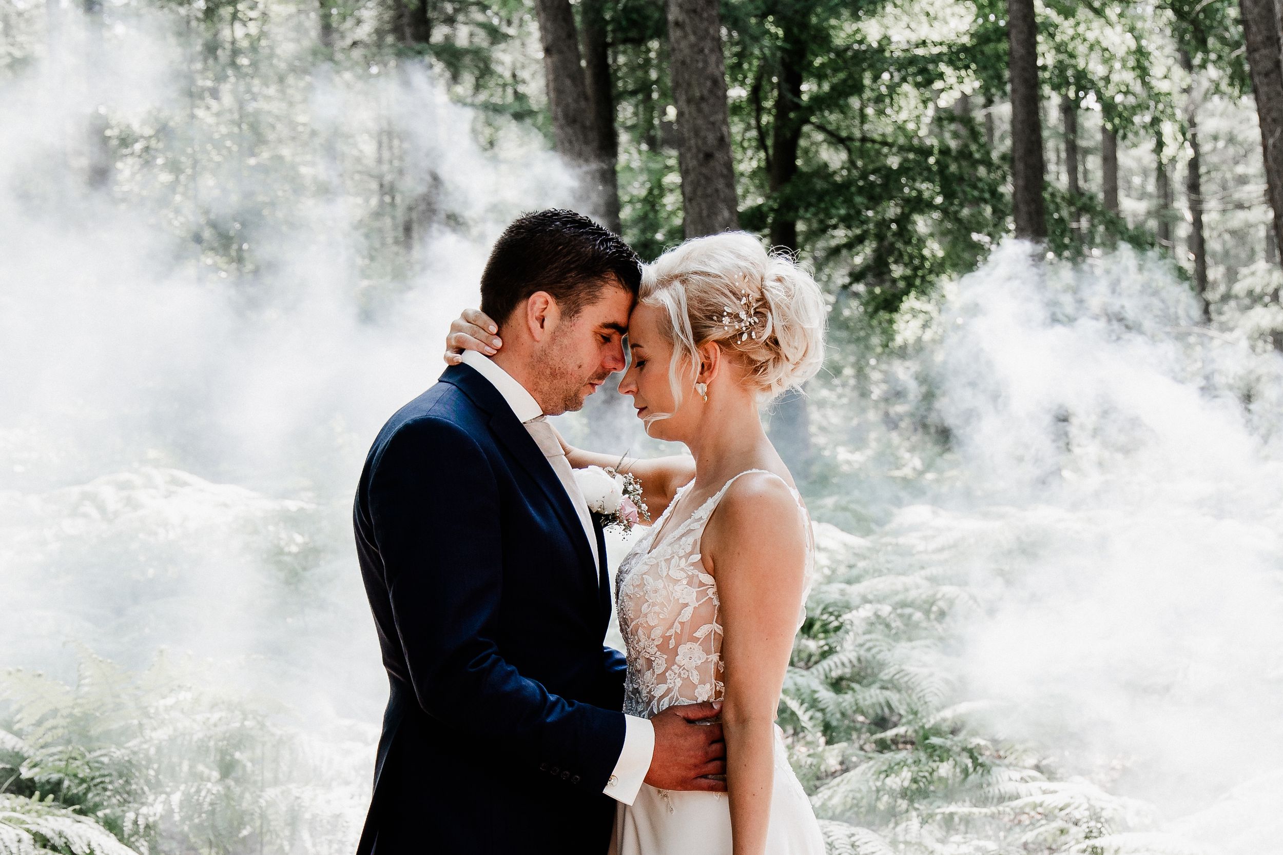 Dreamy wedding portraits in a misty forest setting with natural light.