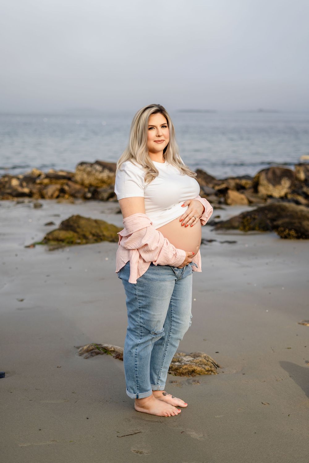 Series of coastal lifestyle photos showing bare feet on a beach with denim jeans and rocks in misty coastal scenery.