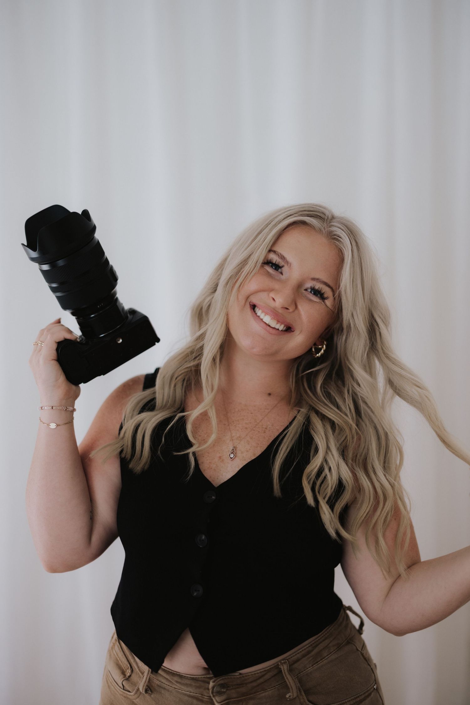 Dynamic photo series showing joyful movements against a white backdrop in casual black attire.
