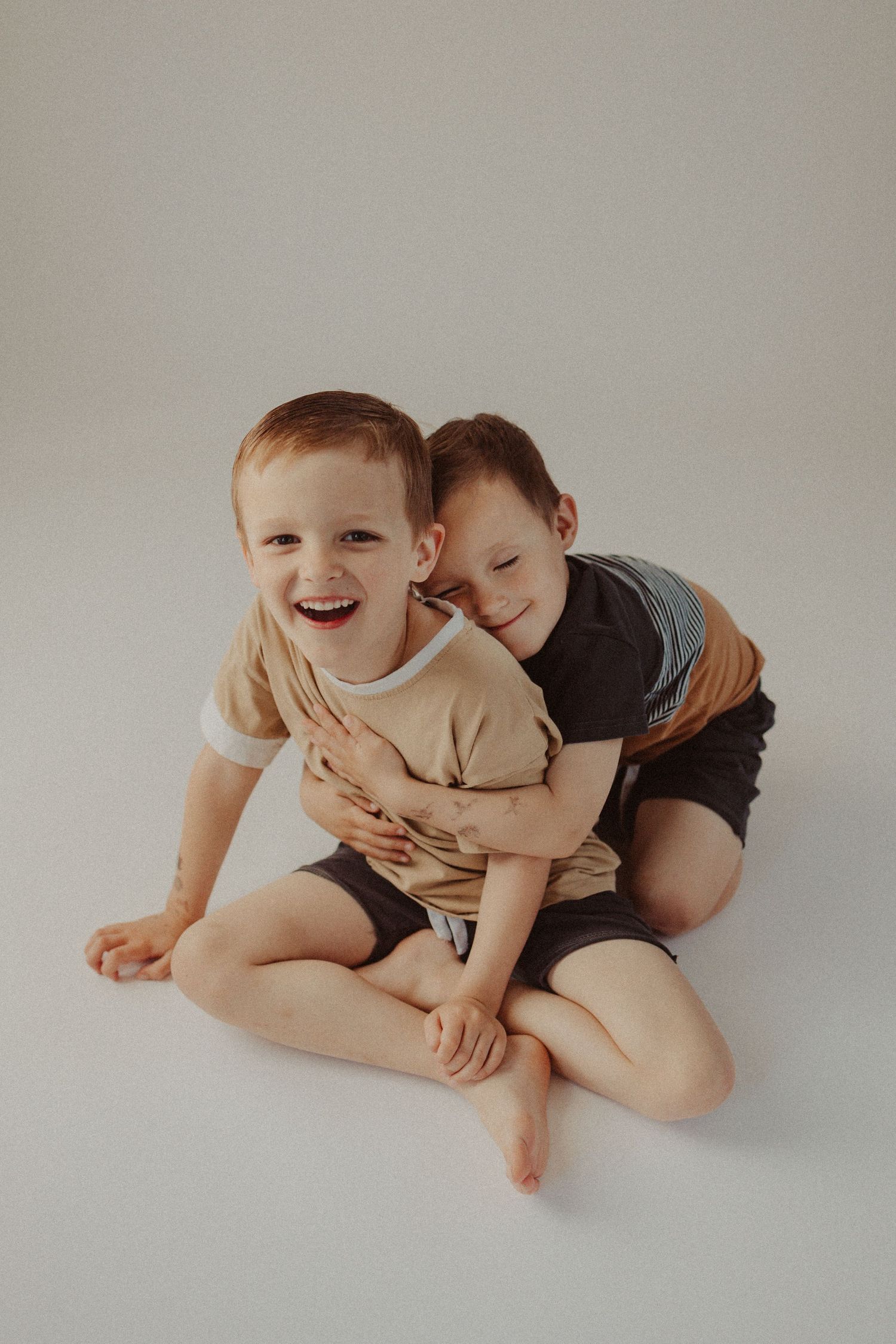 brothers hug for cozy studio session
