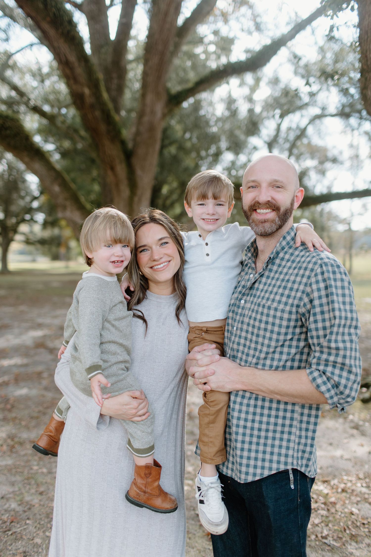 Series of outdoor family portraits taken in a wooded setting with natural lighting.