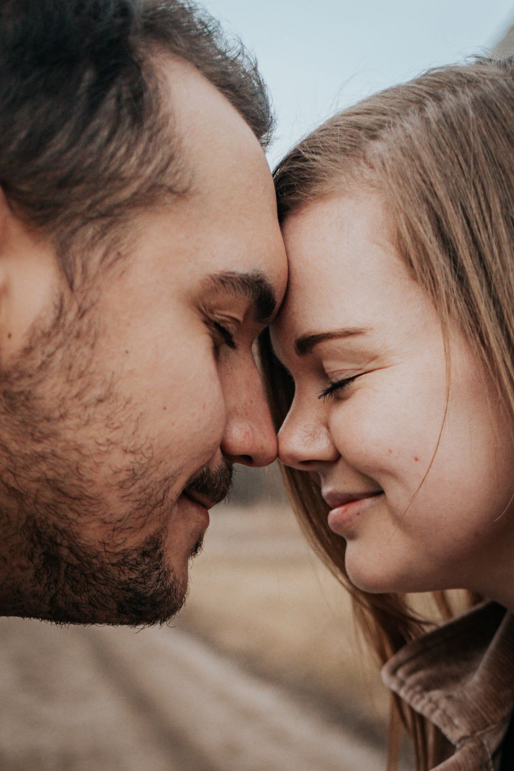 Close-up series of an intimate couple sharing tender moments against a blurred background.