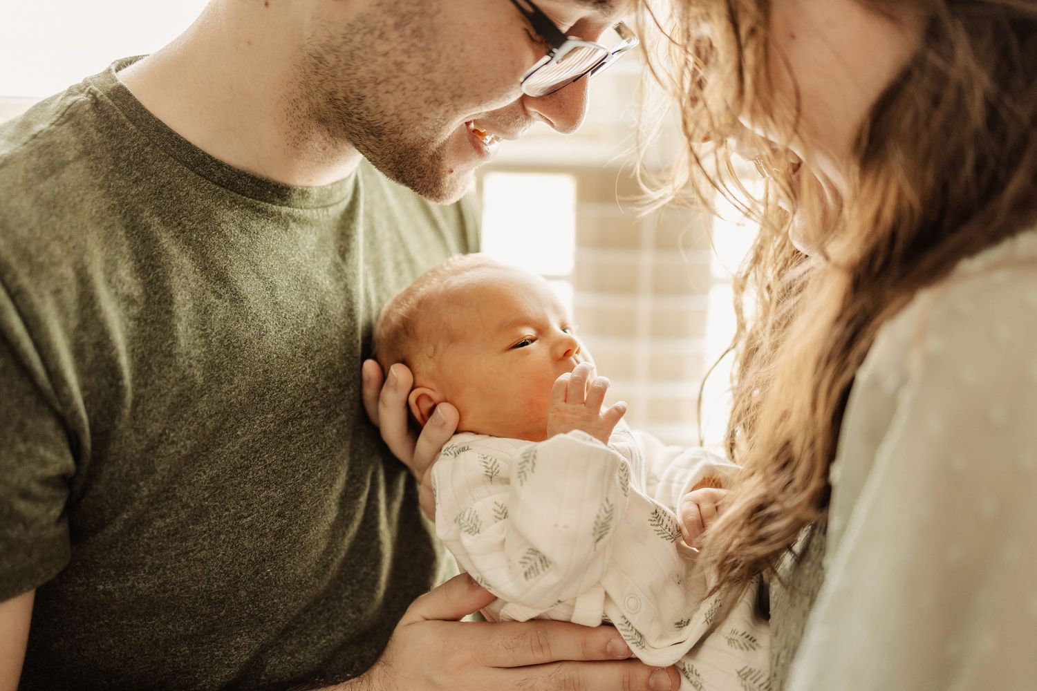 A tender family moment captured in soft, warm lighting indoors.
