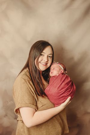 A series of tender moments between a woman in beige and a baby in pink against a muted background.