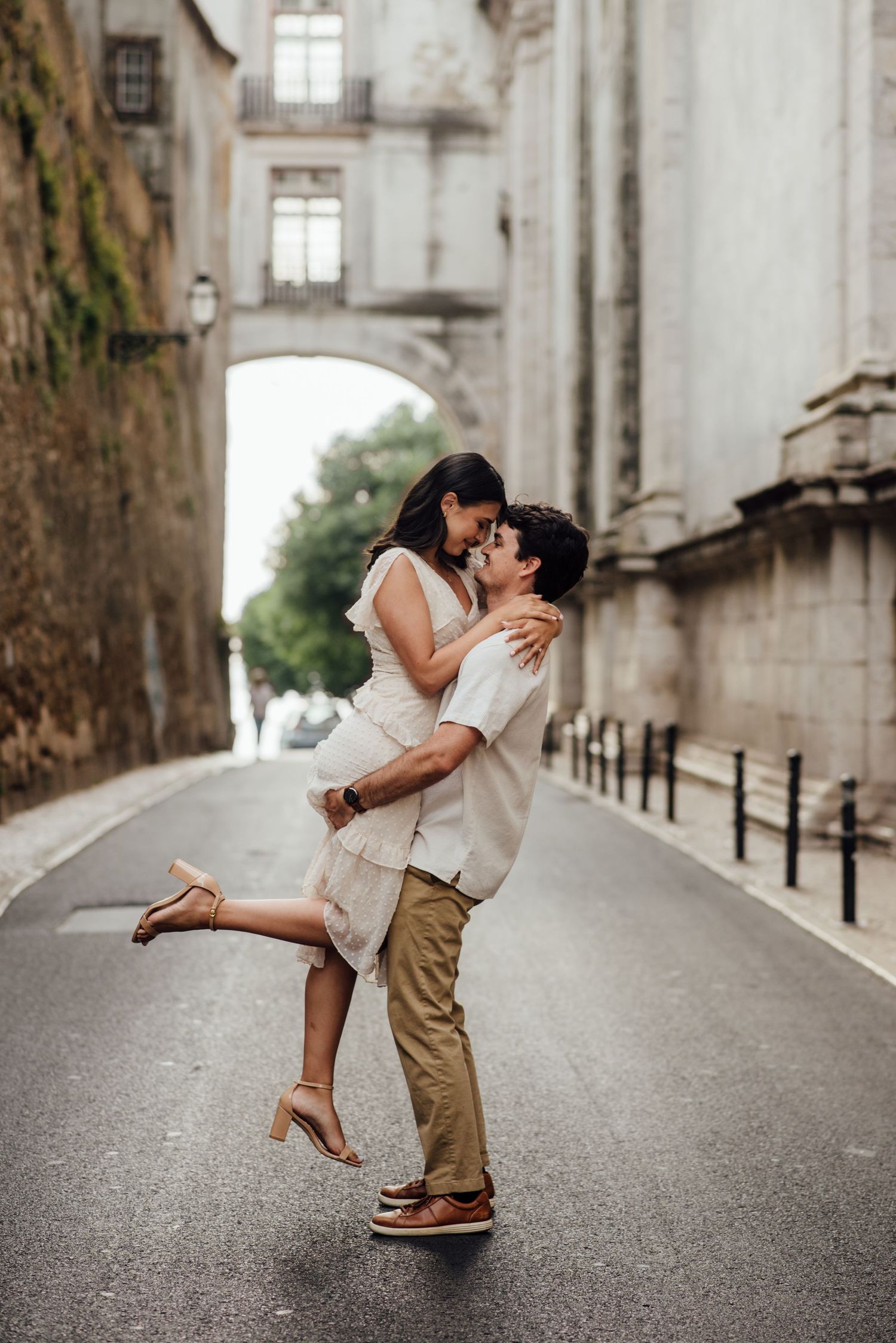 Engagement photoshoot in Lisbon - a couple romantic dance at Sao Vicente arch at morning light.