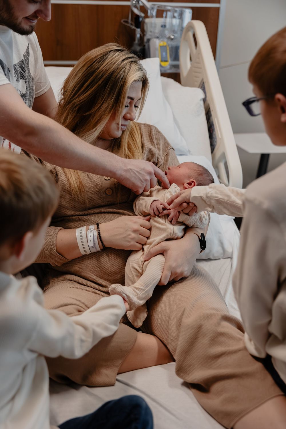Hospital Fresh48 scene showing a newborn baby love by family in Sheboygan, WI  with Essence Rose Photography.