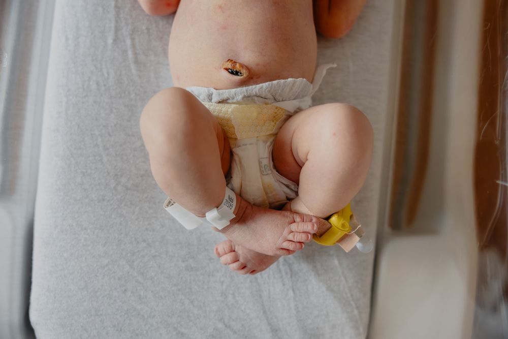 Close-up shot of tiny newborn baby feet during their Fresh48 in the hospital in West Bend, WI  with Essence Rose Photography.