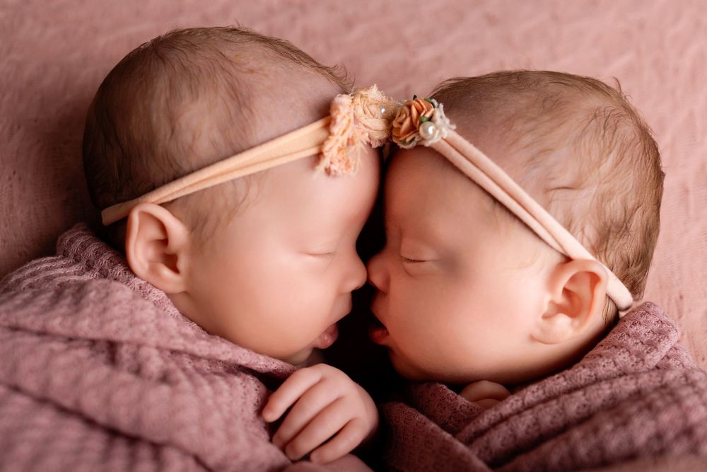 Newborn baby sleeping peacefully on soft pink blanket in artistic collage of multiple poses.