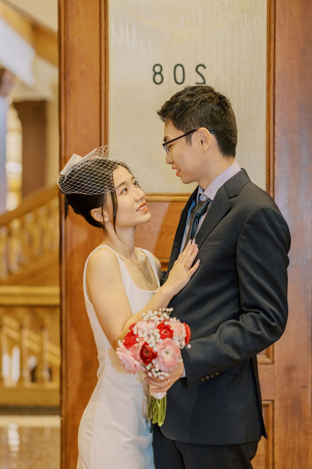 Intimate wedding moments captured in a richly decorated vintage room.