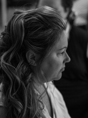 Side profile portrait showing elegant curled hairstyle in black and white.