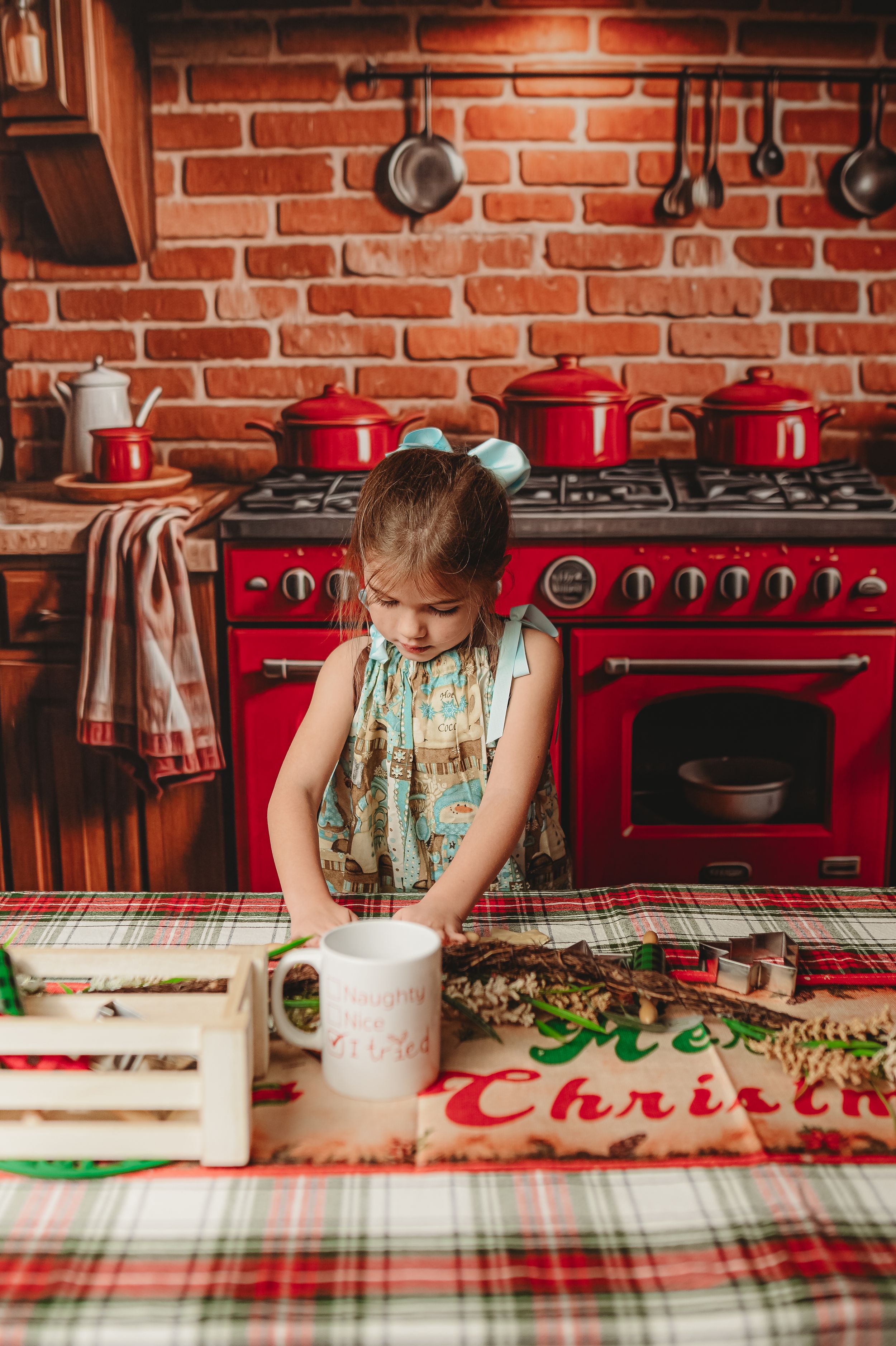 Christmas baking scene in rustic kitchen with red brick walls and vintage cookware.