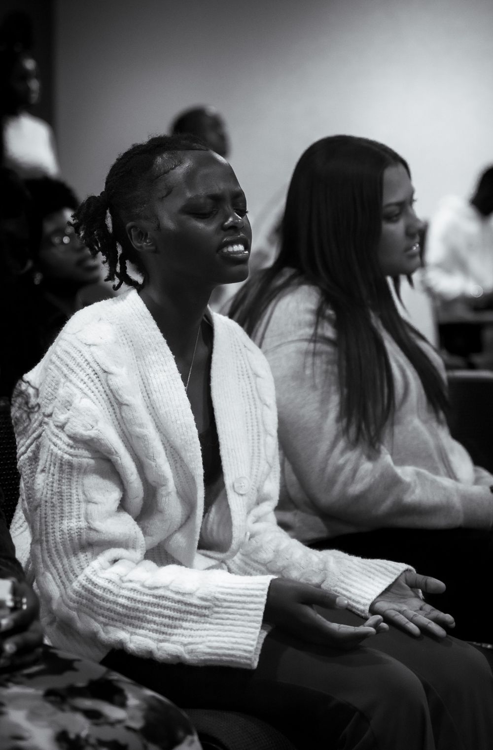 A series of black and white photos showing people laughing joyfully during what appears to be an engaging event.