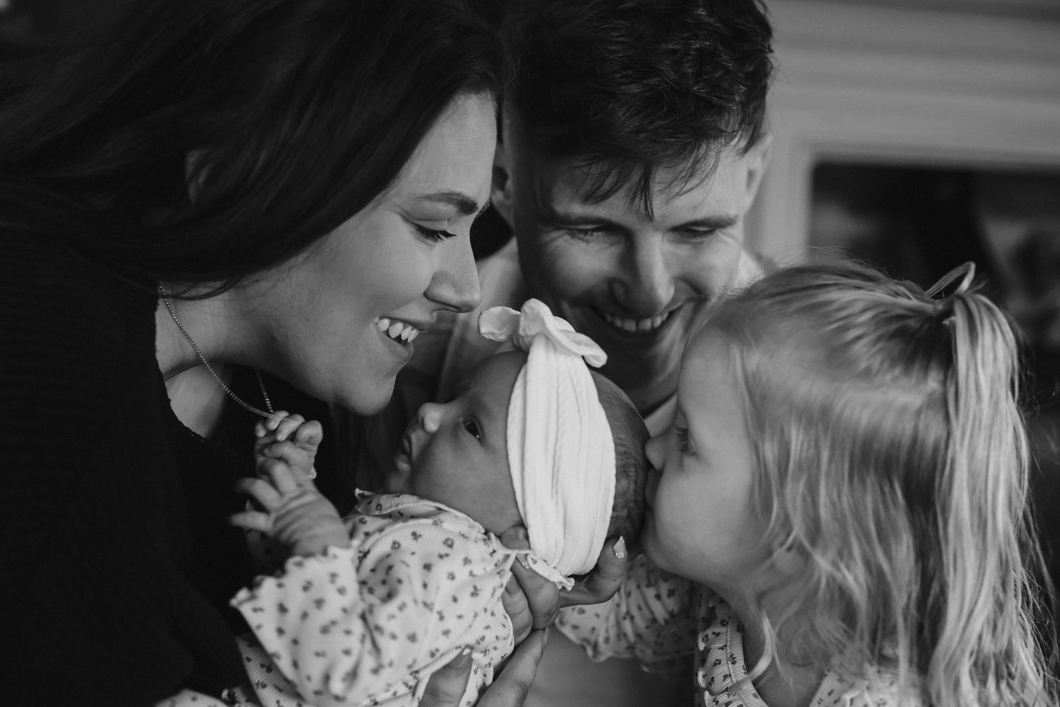 Black and white candid moment showing joyful laughter and interaction.