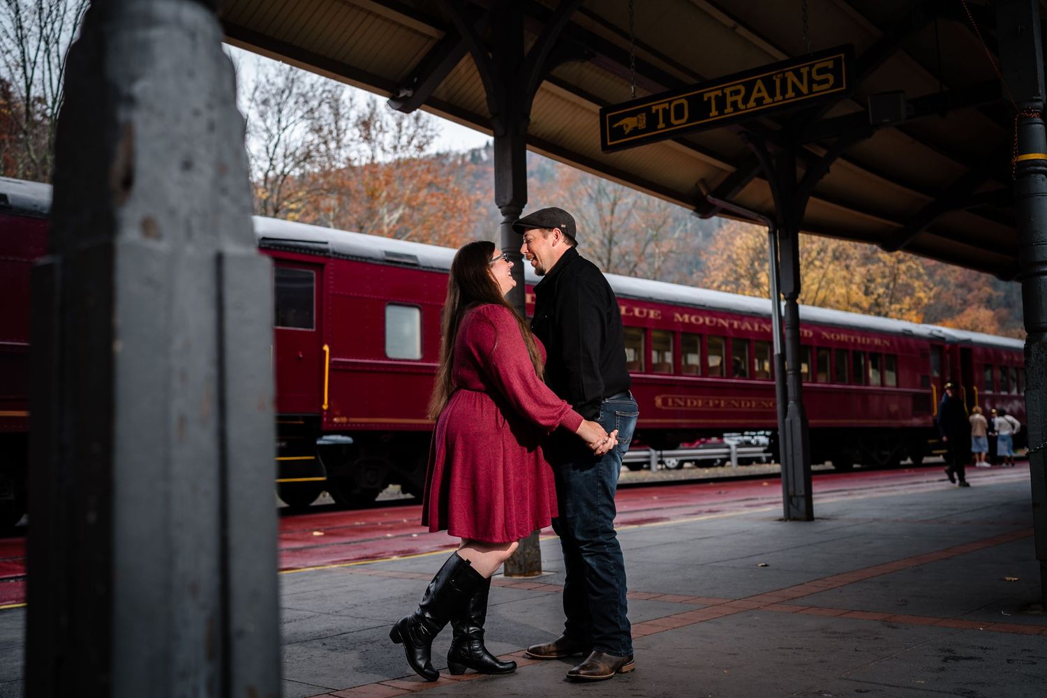 Couple laughing at the Jim Thorpe train station after the proposal
