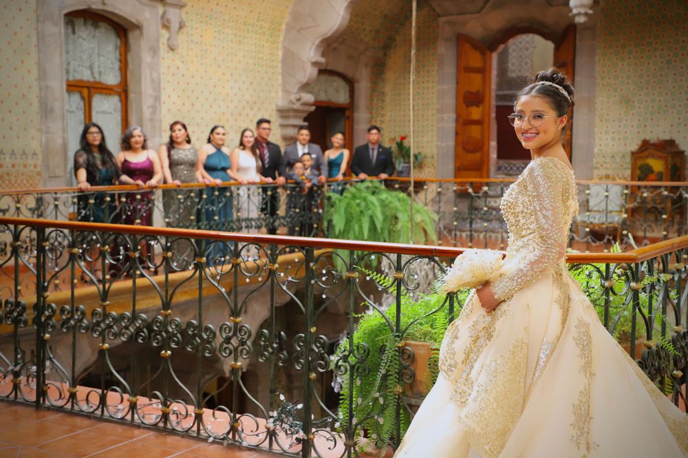 Wedding venue decorated with floral archway and outdoor seating arrangement.