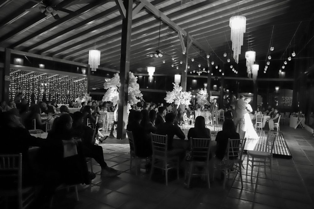 Evening reception venue with dramatic lighting and guest tables.