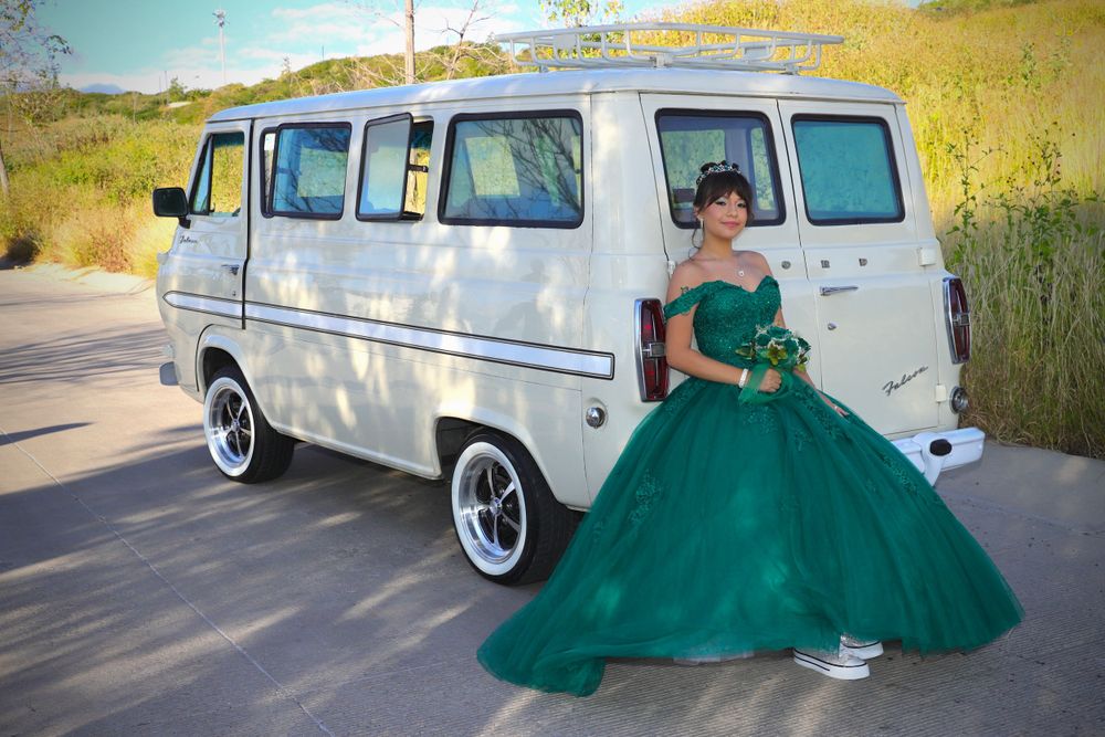 Emerald green ball gown photographed next to vintage white van in natural setting.